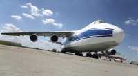 The semi-robotic, pilot controlled tug powers a large commercial aircraft to and from the runway